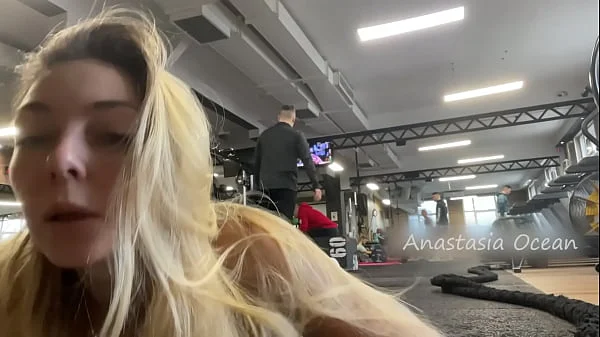 Naughty girl flashing tits in gym right next to the men’s company. Public.