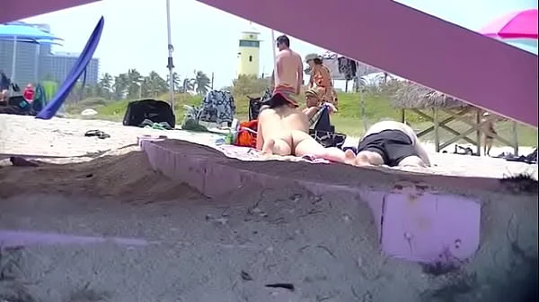 Exhibitionist Wife 63 - Tatiana teasing NUDE BEACH VOYEUR cocks while her hubby takes a nap!