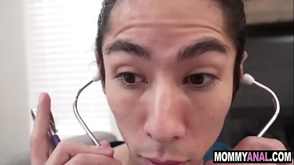 Mature doctor teaches student how to do rectal exam